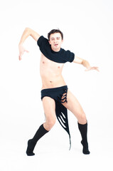 Young attractive man dancing in the studio.
