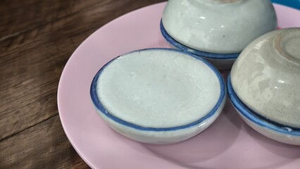kanom tuay Thai dessert coconut milk custard in small porcelain cup .