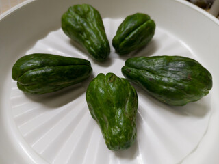 some chayote in a white plastic plate container