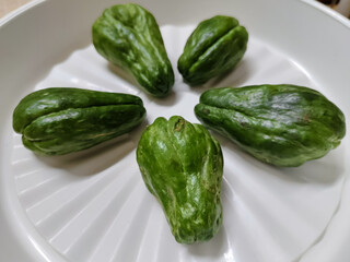 some chayote in a white plastic plate container