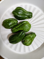 some chayote in a white plastic plate container
