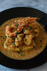 black dish with a fish recipe with shrimp. Food for celebration