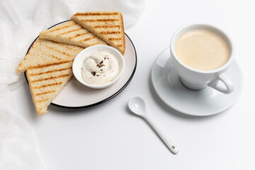 Homemade grilled toasts for breakfast with a cup of black coffee.