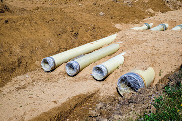 New fiber glass water pipeline in trench. Replacement of old rusty tubes by new one