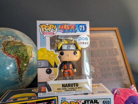 France, 13 August 2024 : Funko Pop Naruto Figurine Surrounded by Globe and Poster Display