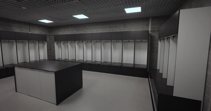 Empty European football team's locker room, dynamic wide angle 4K shot