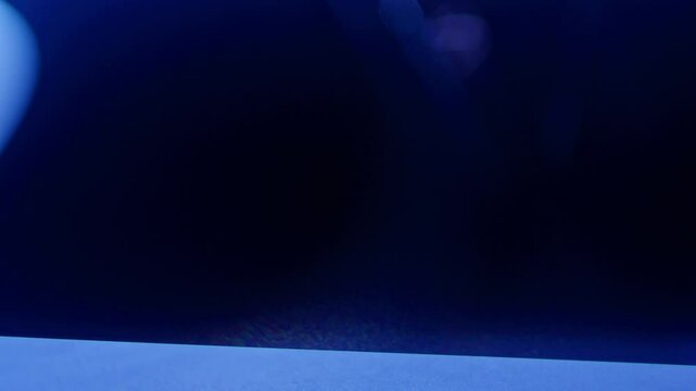 Temporal aliasing blue laser slow spiral effect in smoke creates an eerie ominous science fiction high-tech look for scifi motion graphic asset. Streaks of light move upwards with suspense, close up.