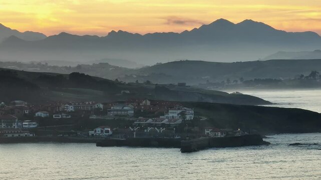 Sunset in Comillas, Cantabria. Cantabrian Sea. Mountains background