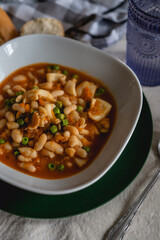 white bean soup casserole with cuttlefish. traditional dish for winter and cold days.