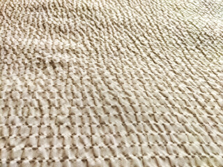 Soft textured fabric background with subtle pattern ideal for overlaying text and creating elegant designs