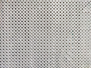 Textured background with perforated pattern suitable for text overlay and design use in creative projects