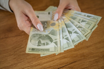 close up of unknown woman hold and count money serbian banknotes