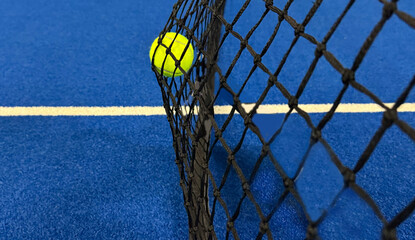 tennis balls in black net