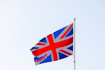 The United Kingdom flag against a clear sky.