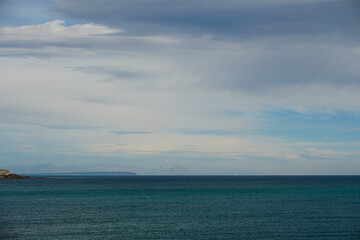 Fototapeta premium Endless spaces. Streams of light and waves of water. Sea, horizon, clouds. Beautiful view. November. 