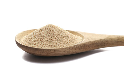 Dry yeast in wooden spoon isolated on white background, side view
