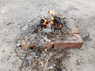 Beautiful photo of isolated bonfire with fierce flames of yellow and orange color depicting incomplete combustion of firewood, set on fire during the winter season to keep the surroundings warm.