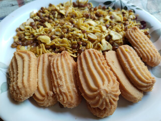 Indian snack: Mixture, Biscuit and Spicy Namkeen in plate for guests