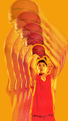 Basketball player preparing to shoot, holding ball high, on vibrant yellow background. Stroboscopic...