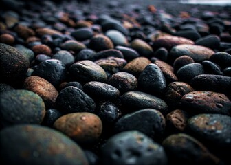 Obraz premium Smooth Black Pebbles with Wet Surface and Natural Glossy Texture in Detail