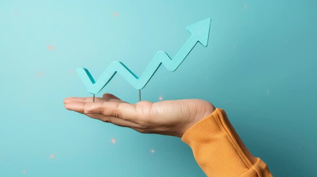 A hand holding an upward trend graph on a blue background, representing growth or success concept.