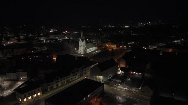 Aerial View of the Dobele City Night Landscape With a Lutheran Church. The Famous Historical Religious Building in the Town Center of Dobele, Latvia. Dobele City Panorama Nightscape