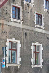 Old multi-story building wall with wooden arches