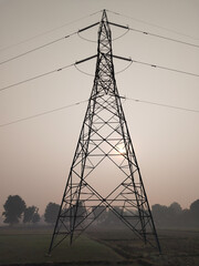 morning in Agricultural Field overlooking High Tension Electric Tower. Electricity concept, Close...