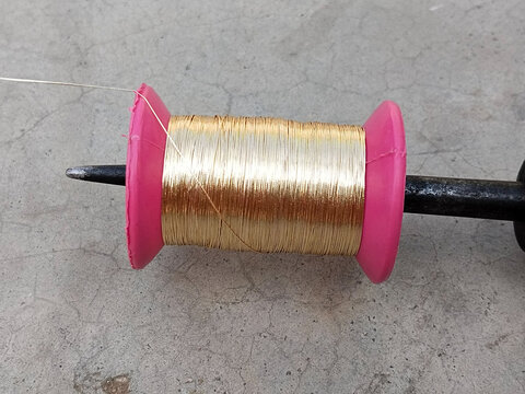 Part of the zari weaving loom with thread reels in Varanasi city. India. pirn bobbin for zari border saree