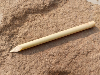 Traditional calligraphy pencils isolated on stone background. Ottoman, Arabic, Persian and orient culture. Calligraphy, arts, lettering, wooden concepts. Horizontal macro shot. Indian Mughal dynasty
