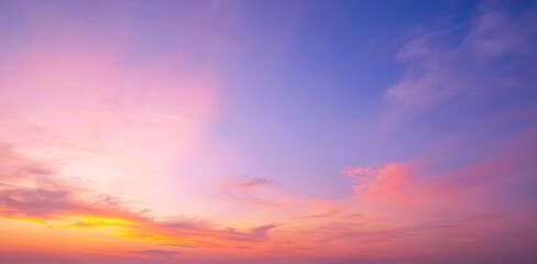 Sunrise sky background in early morning with dramatic clouds and colorful orange yellow sunlight on blue sky. Beautiful summer sunset horizon sky backdrop, Panoramic View