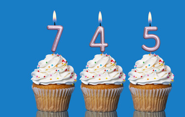 Birthday Cupcakes With Candles Lit Forming The Number 745