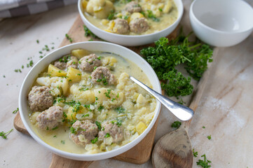 Delicious homemade cooked potato cauliflower soup with meatballs on a plate