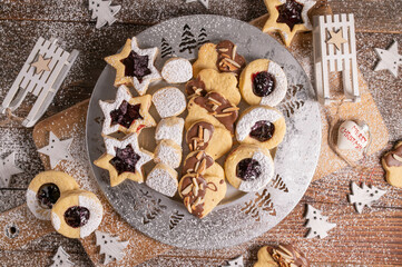 Variation of homemade christmas cookies. Traditional german egg yolk cookies on a silver plate on wooden table