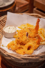 Close up, Deep-fried squid with tartar sauce on a round dish and place on wooden slab