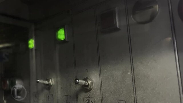 Vintage control panel of old train systems. Green and red indicator lights are on and flashing. Various switches and symbols for controlling the train car.