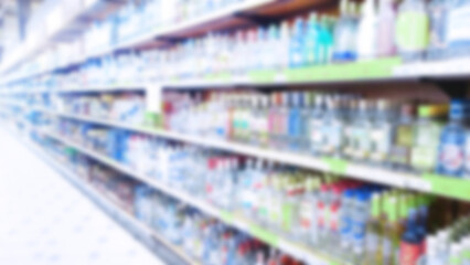 Abstract blur supermarket background. Defocused shelves with bottles of alcohol, vodka, cognac, brandy, wine, beer. Retail industry. Price. Sale regulation. Ban. Inflation. Tariffs. More