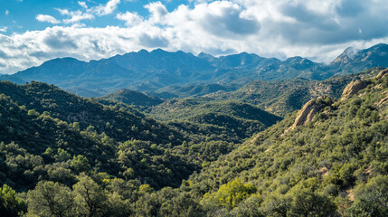 Majestic mountain landscape with rolling hills and vibrant greenery in afternoon light