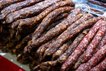 Fototapeta premium Assorted Cured Meats Showcase at a Local Market