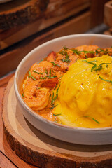 Close up, Creamy omelet with tom yum kung served with rice on dish, place on wooden board