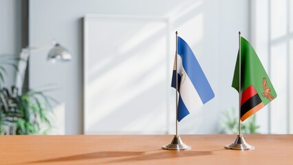 FLAGS OF NICARAGUA AND ZAMBIA ON TABLE