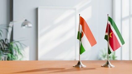 FLAGS OF NIGER AND SURINAME ON TABLE