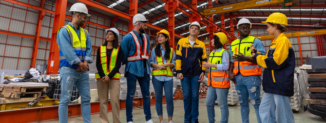 A group of mechanical engineers from different cultures and ethnicities get together in front of the metal steel factory express their commitment to get the project done. Diverse cultures in workplace
