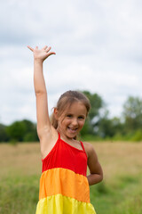 Obraz premium Little happy girl waving her hand
