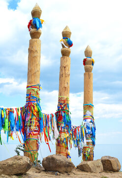 Shamanic serge pillars with Hadak ribbons on Olkhon Island, Lake Baikal, Russia. A sacred and spiritual place for rituals and local traditions