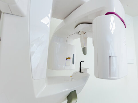 Modern dental clinic equipment performing a cone beam computed tomography scan