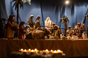 Jesus Christ nativity scene inside church in Europe during Advent. Puppet figurines, candlelights,...