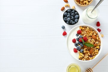Delicious granola with berries and yogurt on a light background