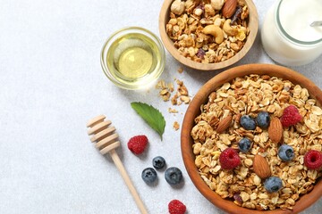 Delicious granola with berries on a light background