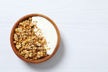Delicious granola with yogurt on a light background